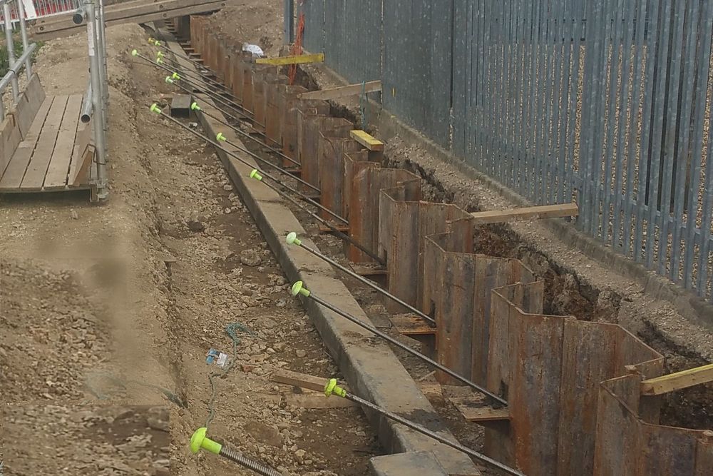 Tie bars and anchors installed along a retaining wall