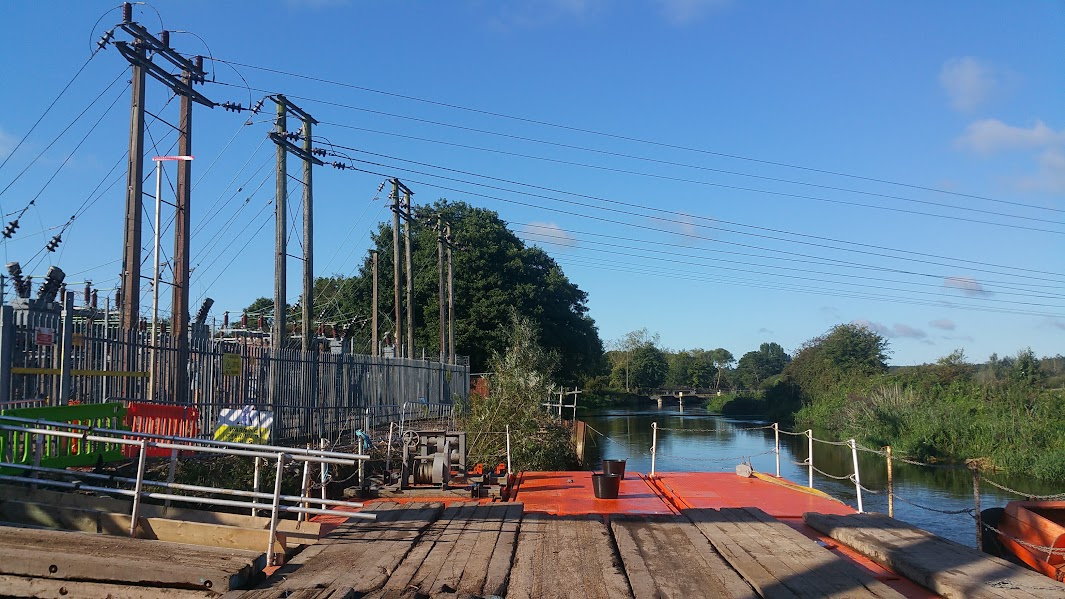 Floating access alongside the substation, showing the river setting and overhead electricity cables