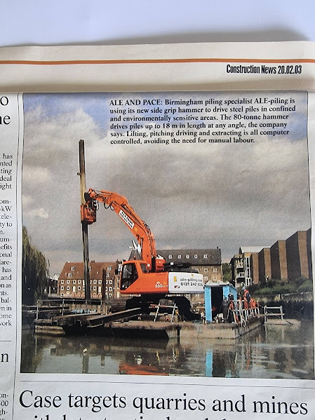 Construction News clipping dated 2003 showing an ALE Piling excavator and piling equipment on a floating platform