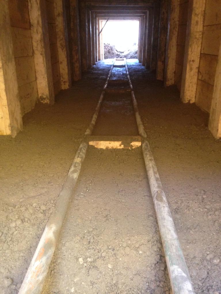 Timber heading with slide rails for moving spoil